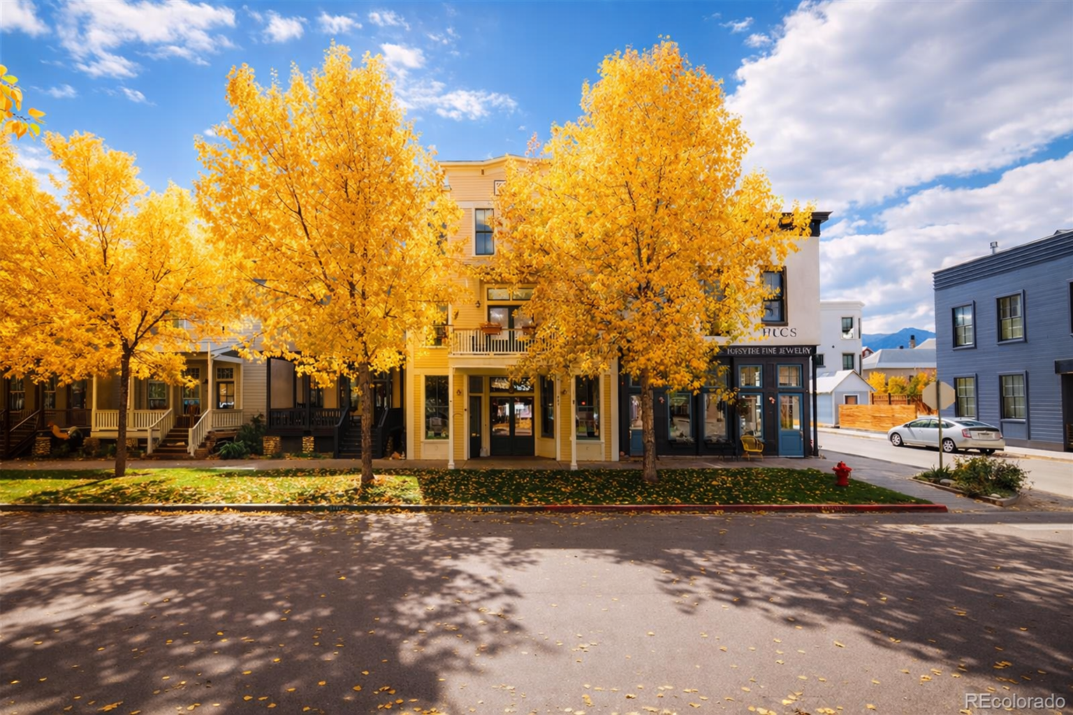 Historic yellow building on a Downtown Buena Vista street framed by golden autumn trees