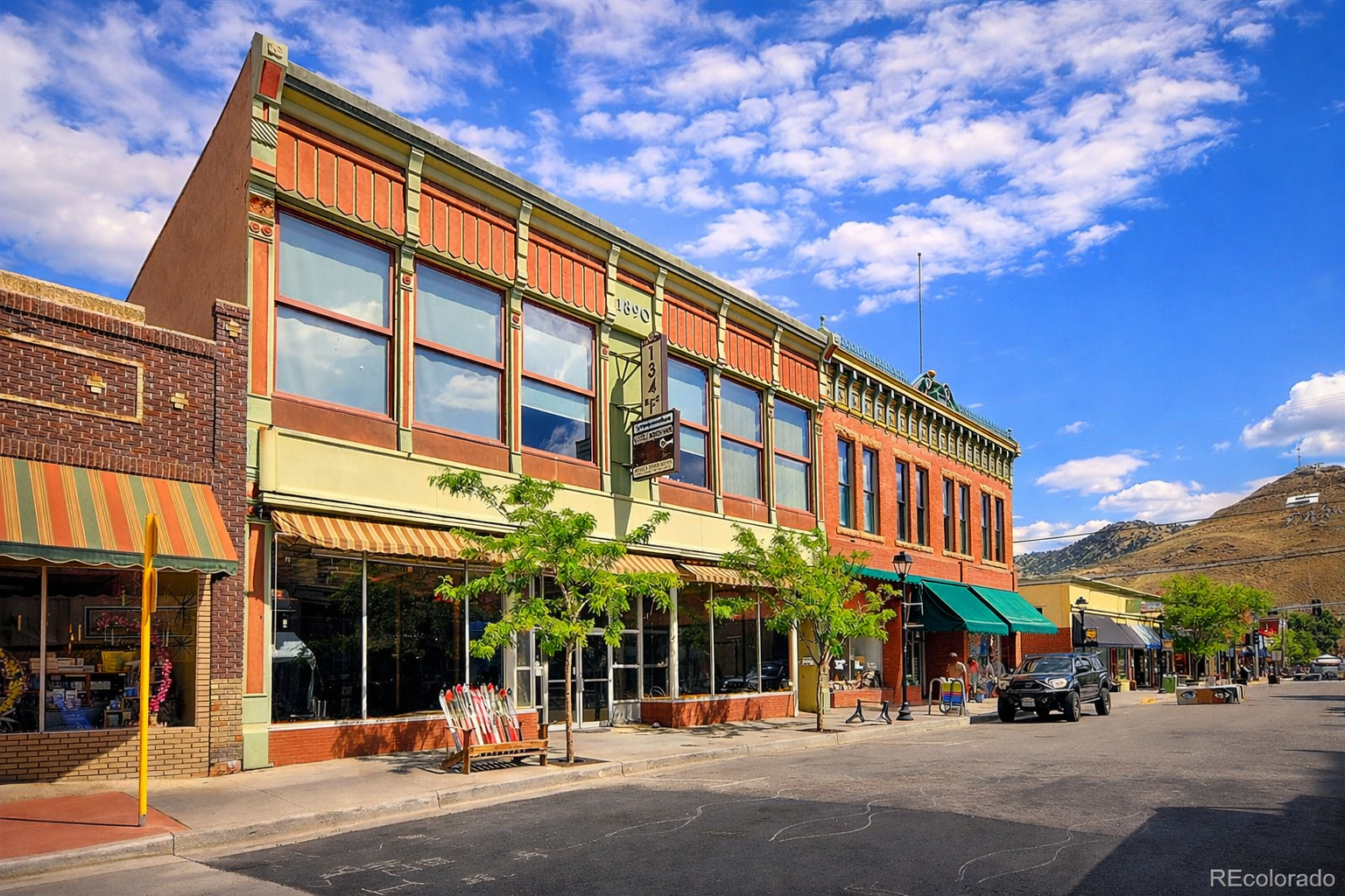 Historic downtown Salida brick storefronts along F Street with mountains in the distance