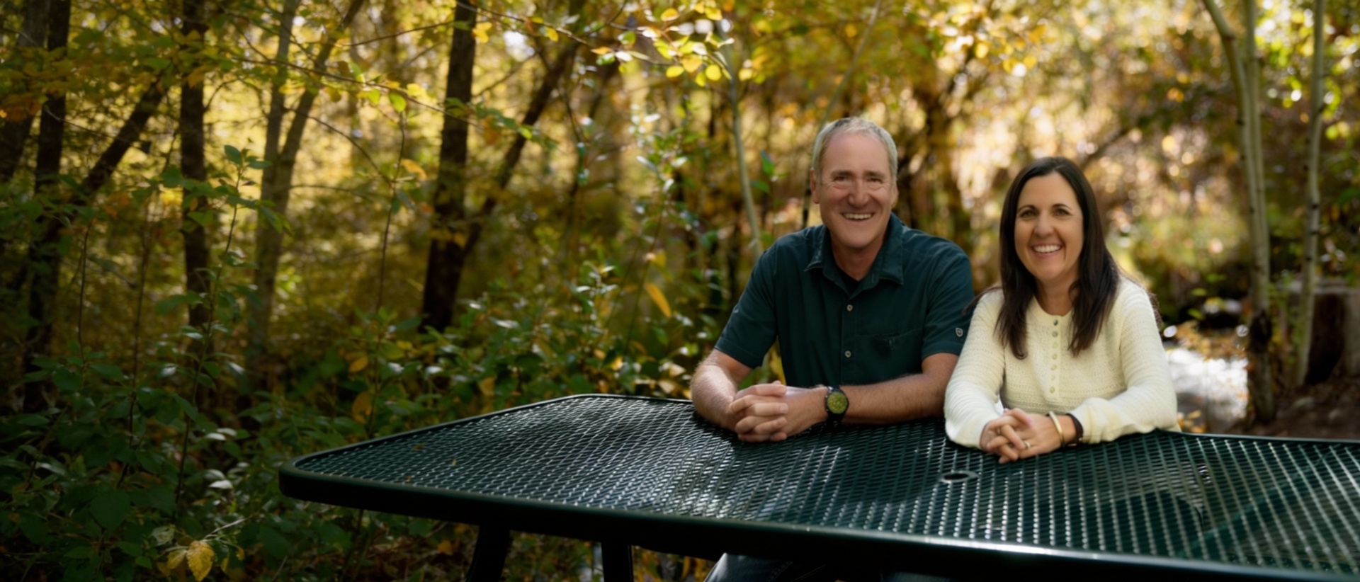 Shawn and Jillian, LiveInSalida realtors, smiling at an outdoor table