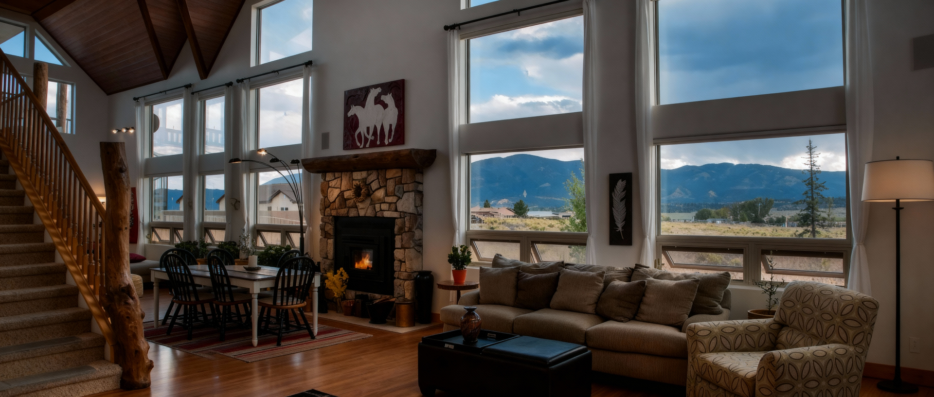 Living room of a Salida mountain home with floor-to-ceiling mountain views