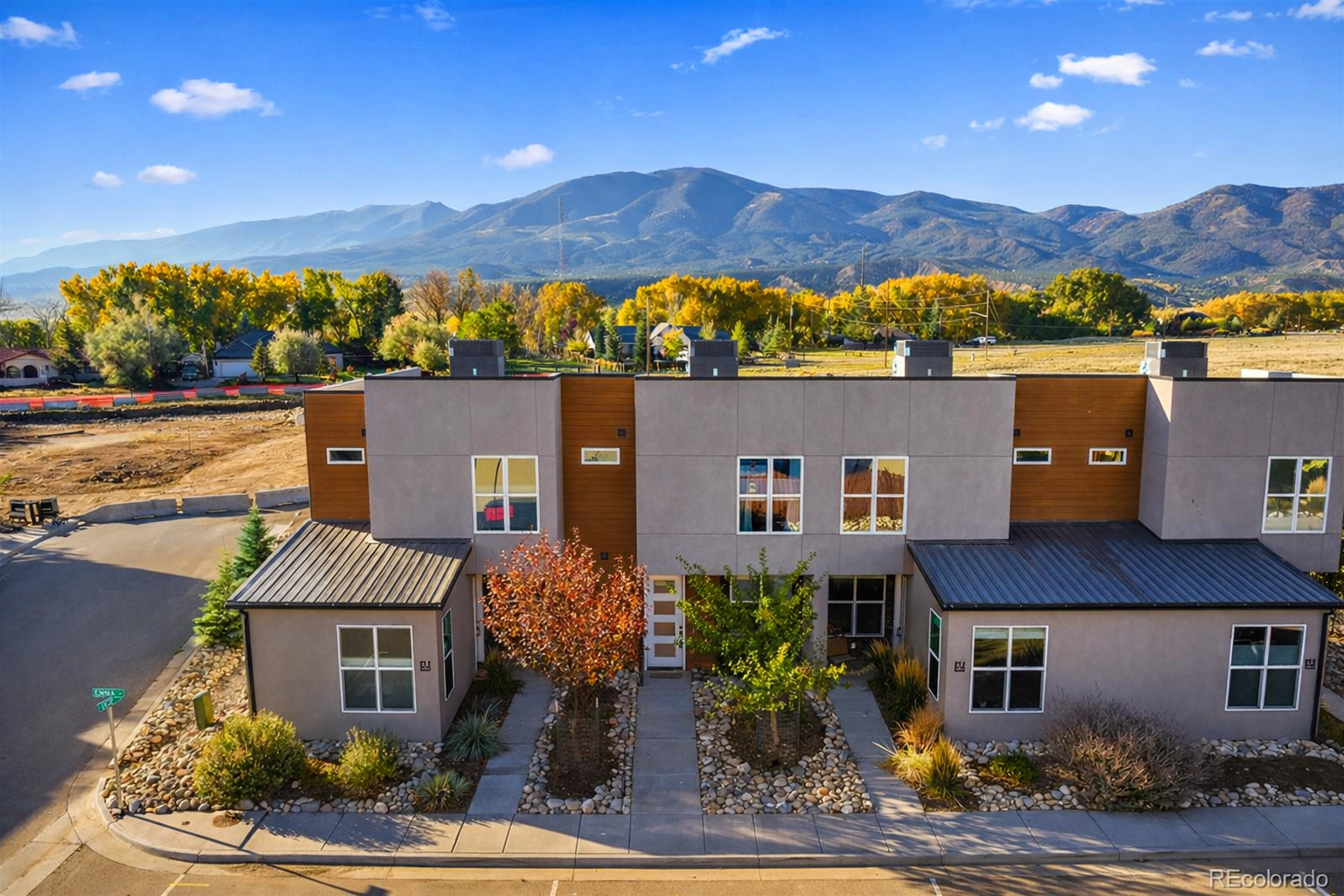 Modern new construction townhomes with mountain views behind them