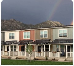 Multi-family townhomes with rainbow over mountains